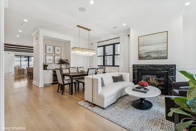 1934 W Patterson Ave, Chicago, IL 60613 - living room featuring light wood-type flooring, a high end fireplace, recessed lighting, and a chandelier