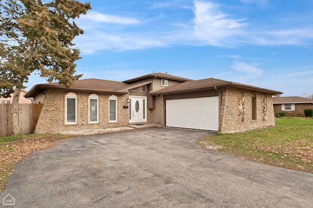 710 E 194th St, Glenwood, IL 60425 - ranch-style home with fence, an attached garage, brick siding, a front yard, and driveway