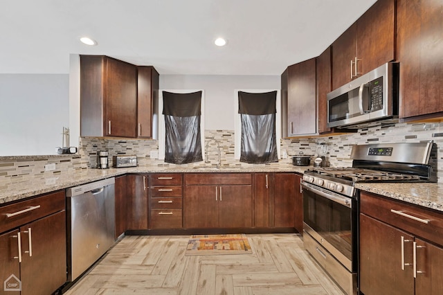 710 E 194th St, Glenwood, IL 60425 - kitchen with a sink, light stone counters, decorative backsplash, and stainless steel appliances