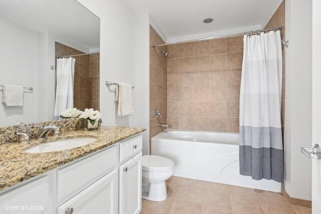 full bathroom with vanity, shower / tub combo with curtain, tile patterned flooring, and toilet