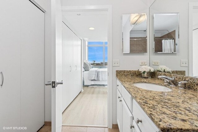 ensuite bathroom with vanity and connected bathroom