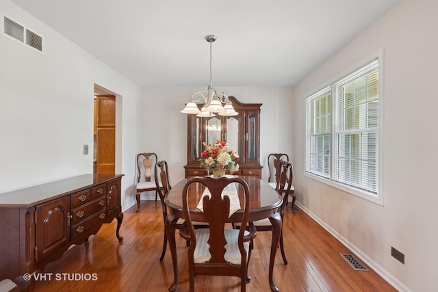 1537 Aberdeen Ct Unit 67, Naperville, IL 60564 - dining room featuring a chandelier, visible vents, baseboards, and hardwood / wood-style floors
