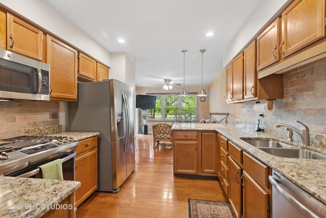 1537 Aberdeen Ct Unit 67, Naperville, IL 60564 - kitchen featuring appliances with stainless steel finishes, light wood-style flooring, ceiling fan, and a sink