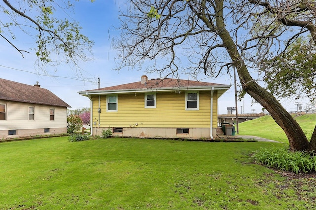 rear view of house with a yard and central AC unit