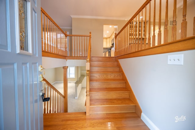 143 Midway Ln, Vernon Hills, IL 60061 - stairway with crown molding, baseboards, a high ceiling, and wood finished floors