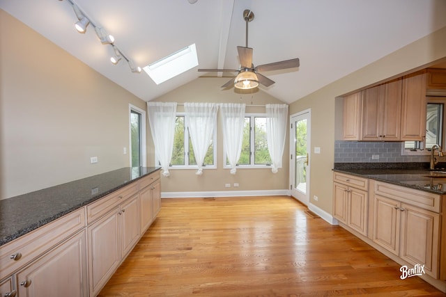 143 Midway Ln, Vernon Hills, IL 60061 - kitchen with a ceiling fan, baseboards, lofted ceiling with skylight, and light wood finished floors