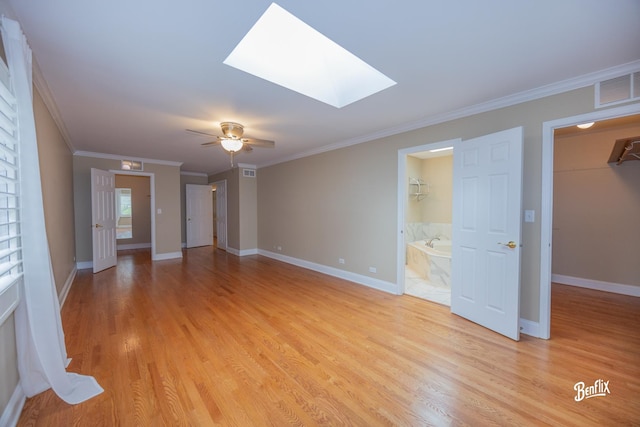 143 Midway Ln, Vernon Hills, IL 60061 - unfurnished living room featuring light wood finished floors, baseboards, a skylight, visible vents, and ornamental molding