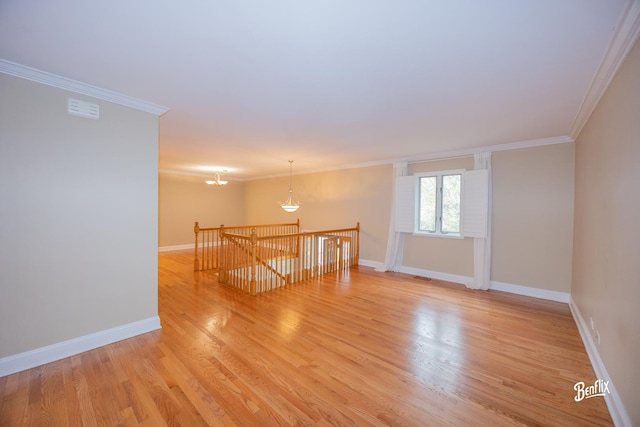 143 Midway Ln, Vernon Hills, IL 60061 - spare room with baseboards, ornamental molding, light wood-style flooring, and a chandelier