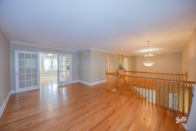 143 Midway Ln, Vernon Hills, IL 60061 - empty room with baseboards, ornamental molding, light wood-style flooring, and a notable chandelier