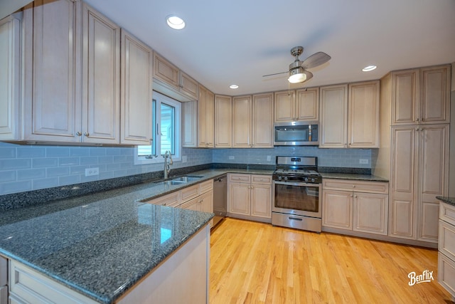 143 Midway Ln, Vernon Hills, IL 60061 - kitchen featuring a sink, appliances with stainless steel finishes, light wood-style floors, and dark stone counters