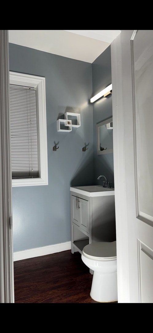 3824 W Grenshaw St, Chicago, IL 60624 - bathroom with vanity, wood finished floors, baseboards, and toilet
