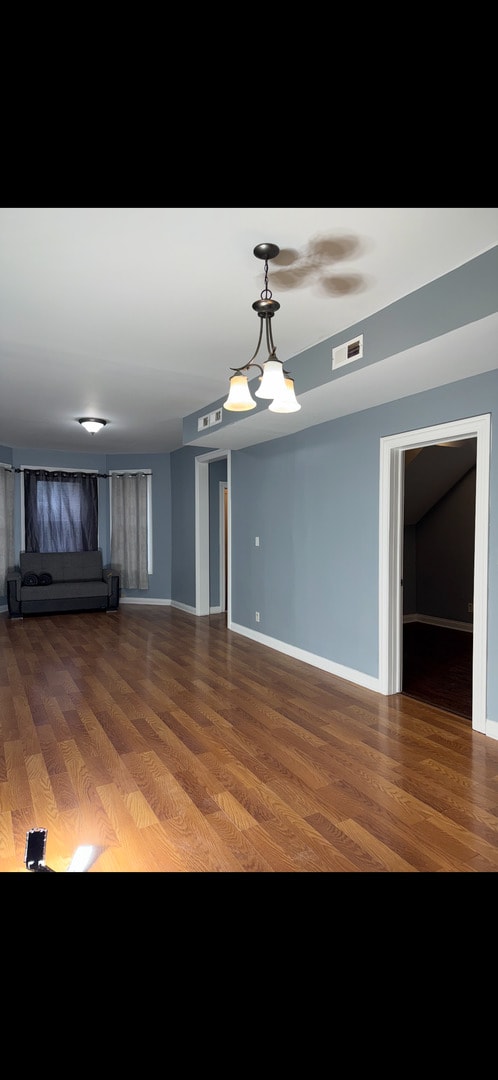 3824 W Grenshaw St, Chicago, IL 60624 - unfurnished room featuring wood finished floors and baseboards