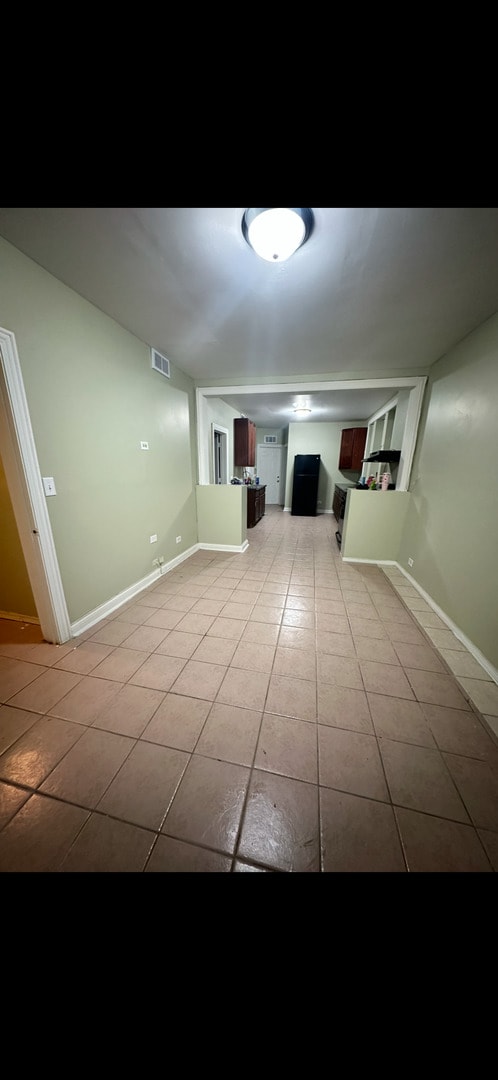 3824 W Grenshaw St, Chicago, IL 60624 - spare room with light tile patterned floors and baseboards