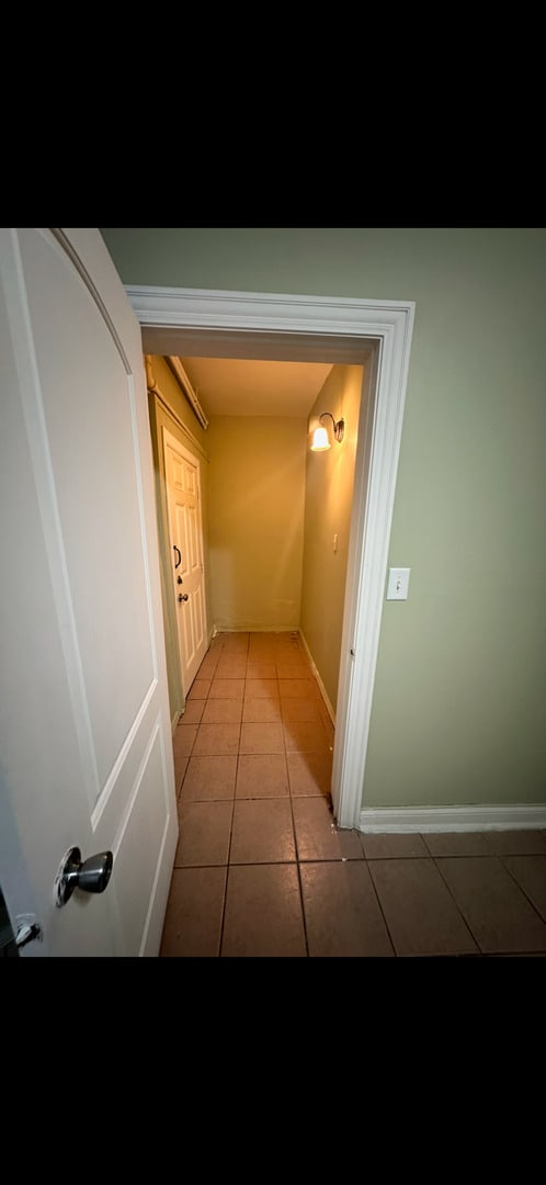 3824 W Grenshaw St, Chicago, IL 60624 - hall with light tile patterned flooring and baseboards