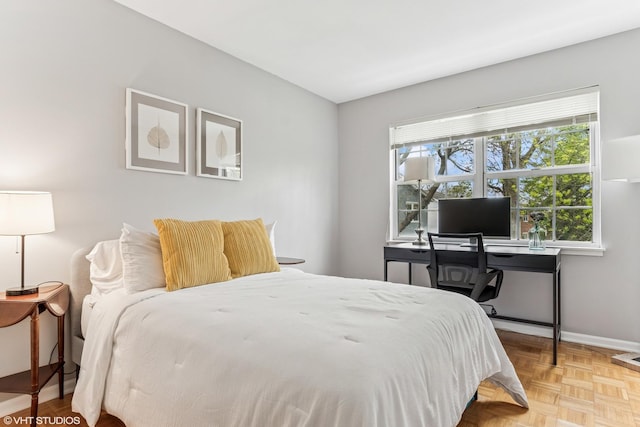 bedroom featuring baseboards and multiple windows