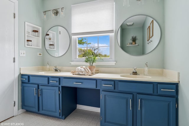 full bath featuring double vanity, a sink, and tile patterned flooring