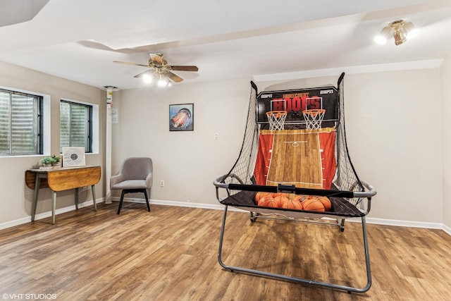 interior space featuring baseboards, ceiling fan, and wood finished floors