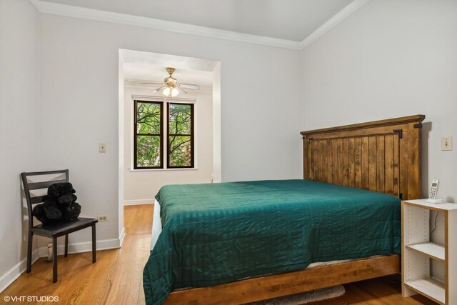 bedroom featuring baseboards, ornamental molding, and wood finished floors