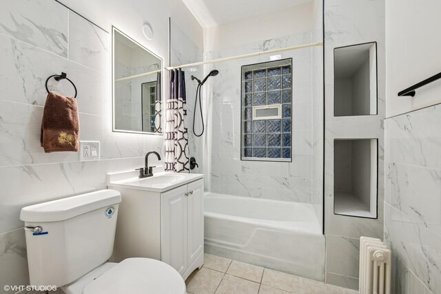 bathroom featuring radiator, toilet, tile walls, tile patterned floors, and shower / bath combo
