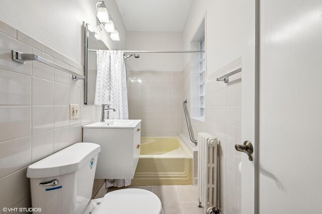 bathroom featuring toilet, tile walls, radiator heating unit, tile patterned floors, and shower / bath combo