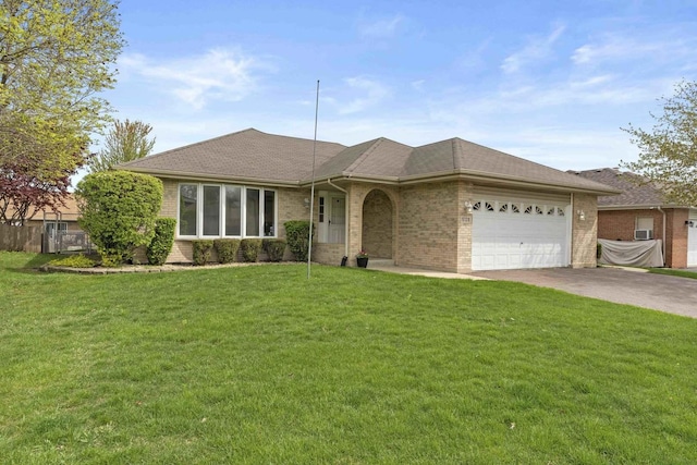ranch-style home featuring brick siding, an attached garage, driveway, and a front yard