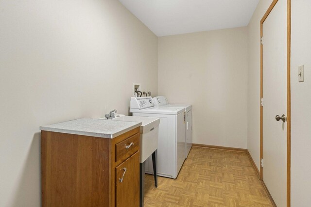 laundry area featuring laundry area, baseboards, and washing machine and dryer