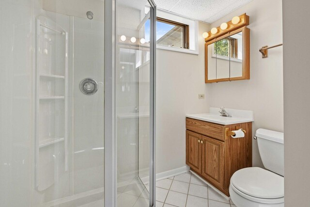 full bathroom featuring toilet, a shower stall, tile patterned flooring, and vanity