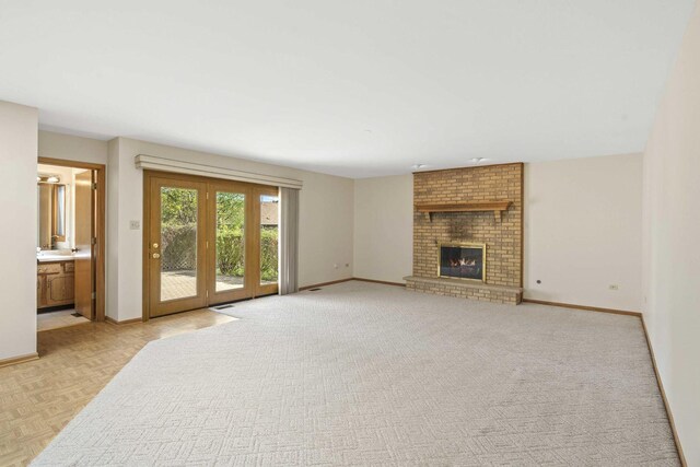 unfurnished living room featuring baseboards and a fireplace