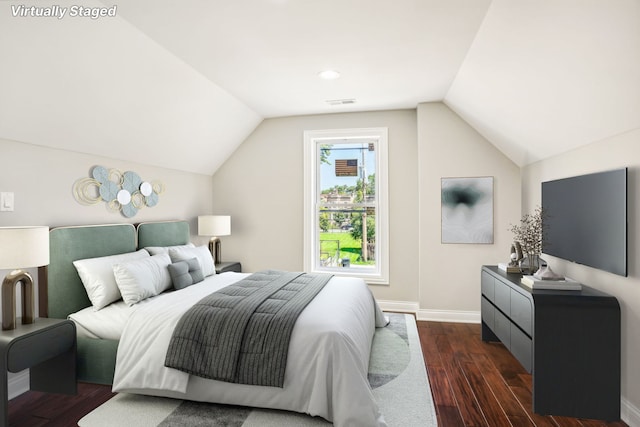 bedroom with dark wood-type flooring, baseboards, and vaulted ceiling