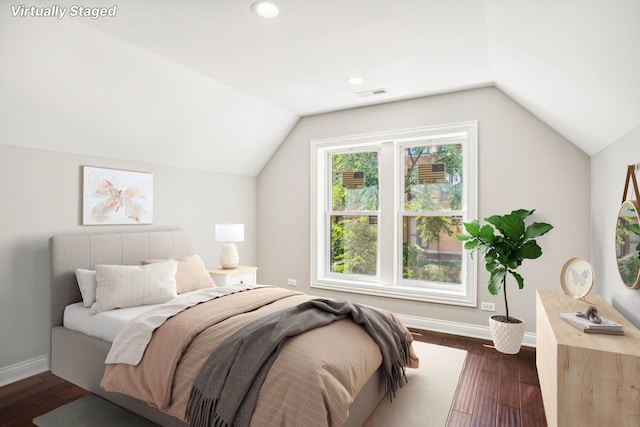 bedroom with dark wood-style flooring, baseboards, and vaulted ceiling