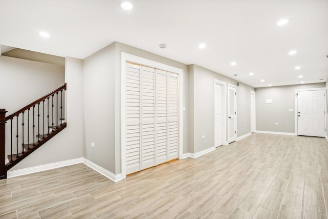 below grade area with light wood-type flooring, recessed lighting, and baseboards
