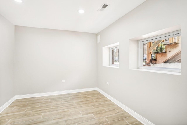 empty room with baseboards, recessed lighting, light wood-style floors, and visible vents
