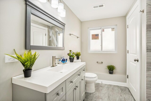 full bathroom featuring visible vents, a tub to relax in, toilet, and vanity