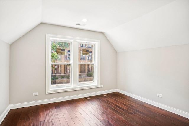 bonus room featuring baseboards, lofted ceiling, dark wood-style flooring, and visible vents