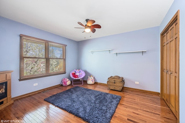 1210 Spring Hill Dr, Algonquin, IL 60102 - game room featuring ceiling fan, light wood finished floors, a glass covered fireplace, baseboards, and visible vents