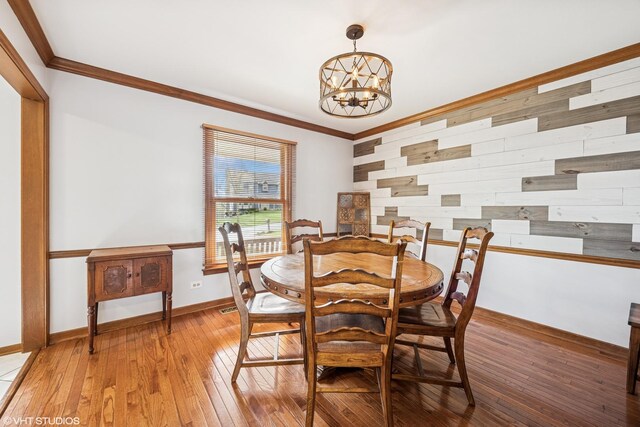 1210 Spring Hill Dr, Algonquin, IL 60102 - dining room with baseboards, an inviting chandelier, ornamental molding, and light wood-style flooring