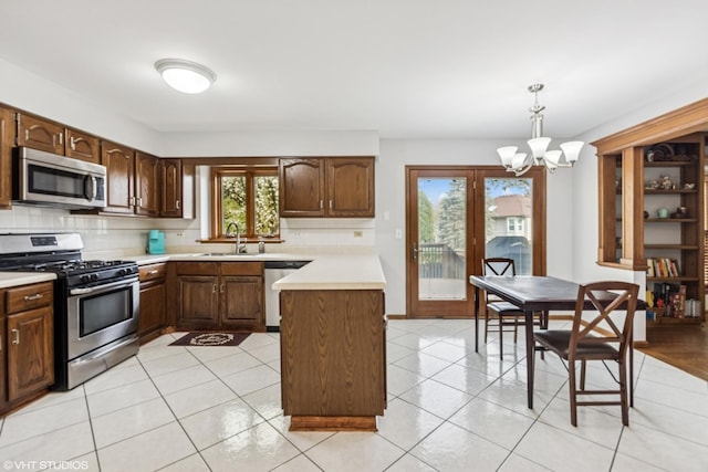 1210 Spring Hill Dr, Algonquin, IL 60102 - kitchen featuring a notable chandelier, appliances with stainless steel finishes, a sink, light countertops, and tasteful backsplash