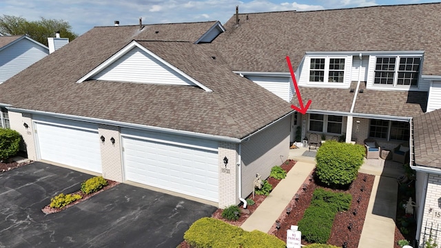 15733 Liberty Ct, Orland Park, IL 60462 - view of front of house with roof with shingles, an attached garage, driveway, and brick siding