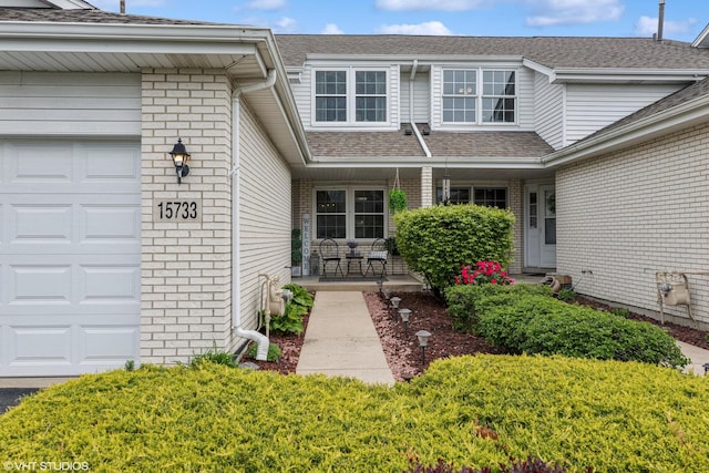 15733 Liberty Ct, Orland Park, IL 60462 - entrance to property with a porch, a garage, brick siding, and a shingled roof