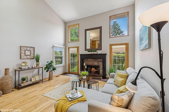 15733 Liberty Ct, Orland Park, IL 60462 - living area featuring a tile fireplace, baseboards, high vaulted ceiling, and wood finished floors