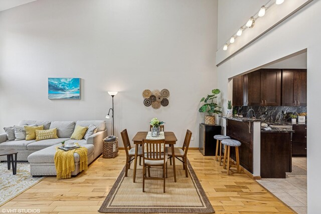 15733 Liberty Ct, Orland Park, IL 60462 - dining room featuring light wood-type flooring and a towering ceiling
