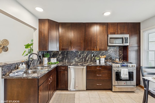 15733 Liberty Ct, Orland Park, IL 60462 - kitchen featuring decorative backsplash, dark stone countertops, appliances with stainless steel finishes, and a sink