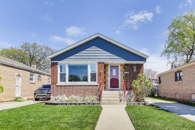 bungalow-style house featuring a front yard and brick siding
