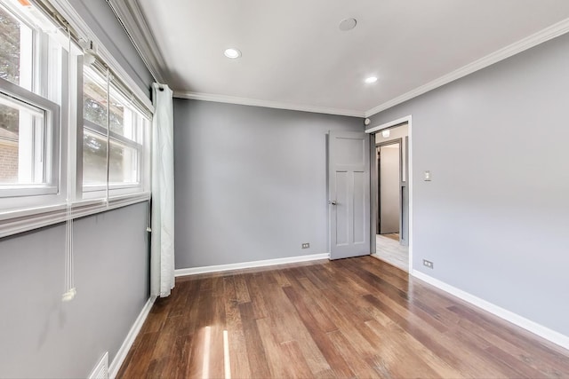 spare room featuring wood finished floors, ornamental molding, recessed lighting, and baseboards