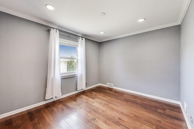 unfurnished room with crown molding, baseboards, hardwood / wood-style floors, and recessed lighting