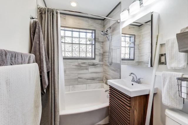 full bath with healthy amount of natural light, shower / tub combo, toilet, and vanity