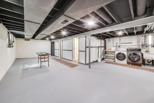 finished below grade area featuring independent washer and dryer and a sink