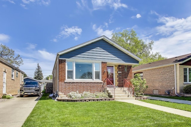 view of front of property with a front lawn and brick siding