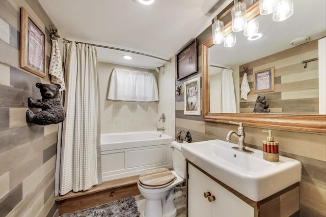bathroom featuring shower / bath combination with curtain, toilet, and vanity