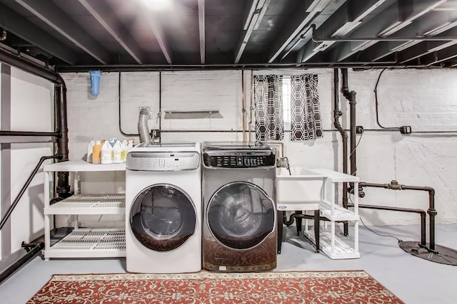 clothes washing area with washing machine and clothes dryer